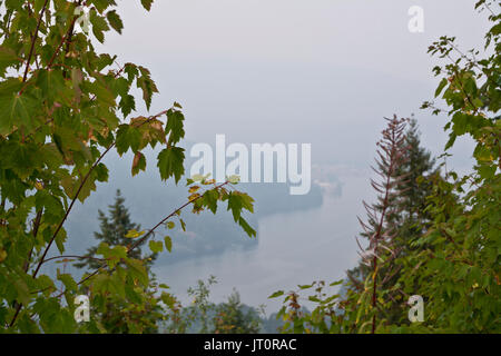 Burnaby BC, Canada (agglomération de Vancouver). 6 août 2017. Vu de Burnaby Mountain, la communauté de Deep Cove, sur la rive nord est à peine visible à travers l'épaisse fumée qui continue de s'attarder sur la région métropolitaine de Vancouver. La fumée provenant de certains des feux dans l'intérieur de la province a été dériver vers la côte Sud pendant plusieurs jours, ce qui a incité les avertissements sur la qualité de l'air. Il y a actuellement 127 feux brûlant dans la province. Crédit : Maria Janicki/Alamy Live News. Banque D'Images