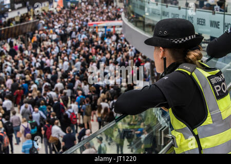 Londres, Royaume-Uni. 07Th Aug, 2017. La police des transports montre de la foule comme Mezzanine atteindre un pic dans le grand hall après 6 heures - dix plates-formes sont fermées à la gare de Waterloo pour tout le mois d'août pour une mise à niveau de plates-formes. Crédit : Guy Bell/Alamy Live News Banque D'Images