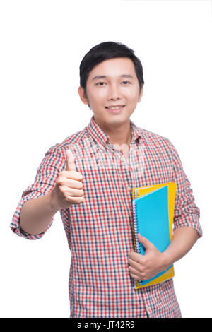 Jeune étudiant asiatique avec book showing thumb up Banque D'Images