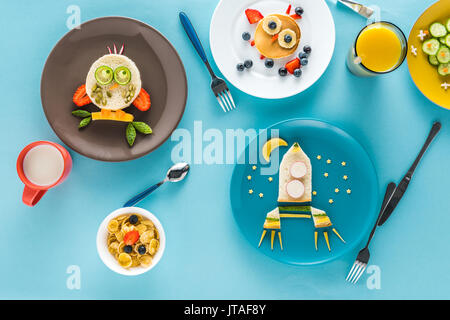 Mise à plat avec un style de façon créative le petit déjeuner des enfants avec des boissons sur les plaques Banque D'Images