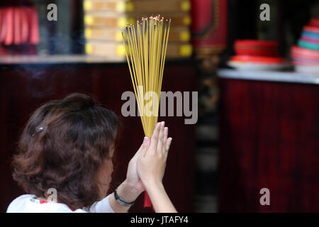 Adorateur d'encens brûlant, temple taoïste, une pagode de Phuoc Hoi Quan, Ho Chi Minh City, Vietnam, Indochine, Asie du Sud-Est, l'Asie Banque D'Images