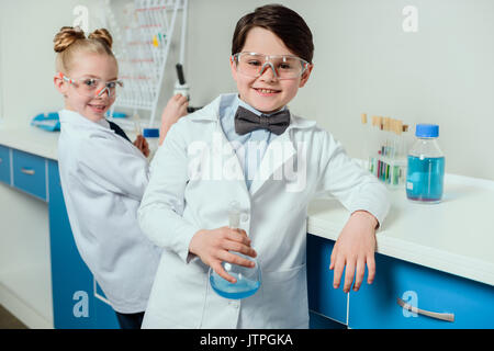 Les écoliers à l'équipement de laboratoire sciences chimiques en laboratoire, les scientifiques kids team concept Banque D'Images