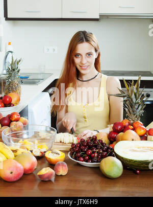 Effets positifs à long-haired woman décisions fruits coupés en salade accueil cuisine Banque D'Images