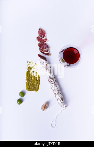 La charcuterie avec du vin, olives, sauce pesto et l'ail. Ingrédients tapas espagnol, snack. Vue ci-dessus. Banque D'Images