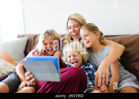 Mère et enfants (4-5, 6-7, 8-9) en tenant avec selfies digital tablet Banque D'Images