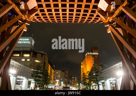 Vue de la porte tambour Tsuzumi, aka gate, à la gare de Kanazawa au Japon. La nuit après la pluie. Vue de l'intérieur du dôme de verre de la rue principale. Banque D'Images