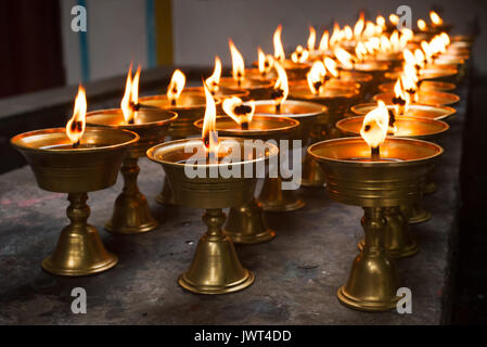 Rangée de bougies allumées dans un temple bouddhiste chinois Banque D'Images