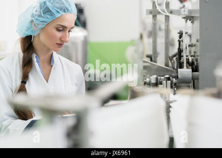 Happy woman employé travaillant comme ingénieur de fabrication dans le facteur Banque D'Images
