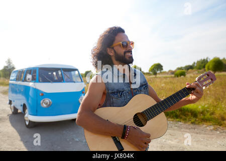 Homme hippie à jouer de la guitare à l'extérieur de voiture minibus Banque D'Images