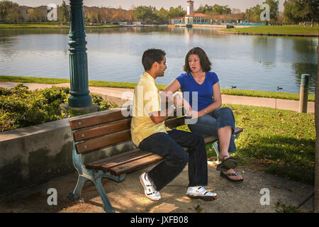 Young teen couple amis amitié parler sur banc de parc conversation Conversation © Myrleen Pearson Banque D'Images