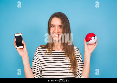 Ufa, Russie - 8 juillet 2017 : woman holding pokéball avec pikachu pokemon rendez jeu multijoueur. Banque D'Images