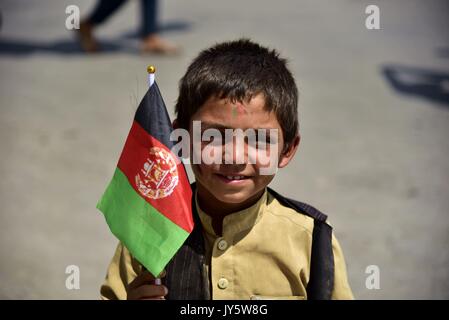 Kaboul, Afghanistan. Août 19, 2017. Un garçon tenant un drapeau national prend part à la célébration de la 98e anniversaire de l'indépendance de l'Afghanistan à Kaboul, capitale de l'Afghanistan, le 19 août, 2017. Afghanistan : le samedi a marqué le 98e anniversaire de son indépendance de l'empire britannique de l'occupation. Credit : Dai il/Xinhua/Alamy Live News Banque D'Images