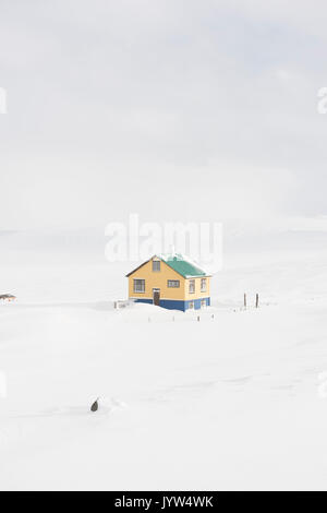 L'Islande, l'Europe. Maison de couleur entouré par la neige en hiver. Banque D'Images