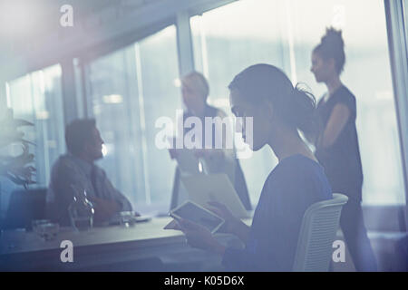 Businesswoman using digital tablet in conference room meeting Banque D'Images