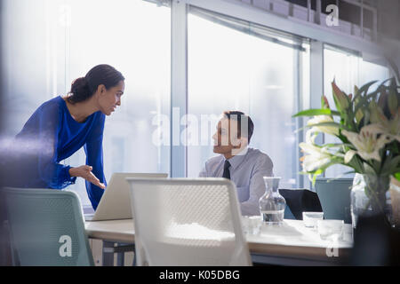 Les gens d'affaires travaillant à l'ordinateur portable, de parler dans la salle de conférence réunion Banque D'Images