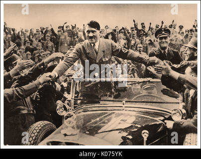 L'adoration d'Adolf Hitler ADORANT SE SERRER LA MAIN LES FOULES AGITANT Adolf Hitler dans sa Mercedes à toit ouvert à l'apogée de sa popularité en serrant la main d'une allemande d'adoration, dont l'approbation publique note pour lui en 1938 était d'environ 96  % Banque D'Images