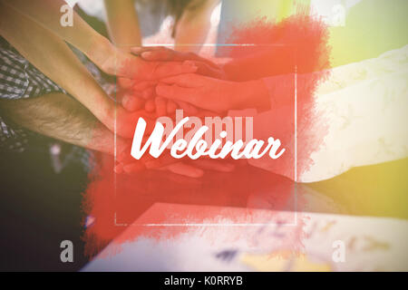 Webinaire sur fond blanc contre l'image recadrée de gens d'affaires stacking hands Banque D'Images
