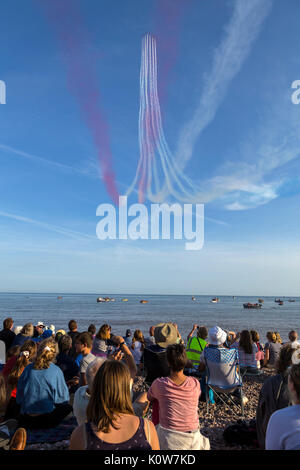 La foule envahit la plage lors d'une soirée glorieuse pour l'exposition des flèches rouges, qui signale le début de la régate de Sidmouth. Banque D'Images