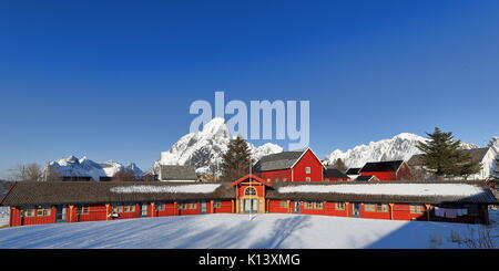 Chalet rouge longue ou rorbu-une fois la pêche saisonnière traditionnelle abris-maintenant pour les touristes en Reine village. -Lilandstinden-Festhaeltind Olstiden-Klokktinden Banque D'Images