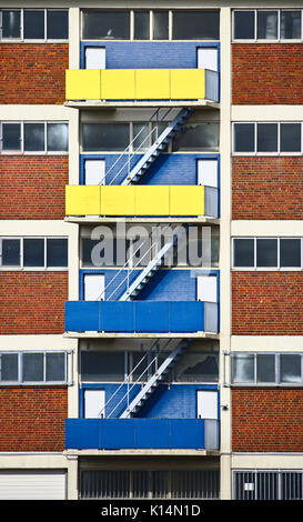 Escalier de trois vols sur le mur extérieur d'un bâtiment sur un balcon bleu et jaune vif Banque D'Images