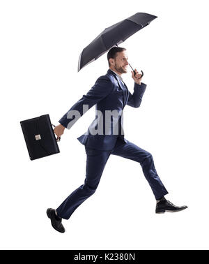 Businessman running avec parapluie et porte-documents. Banque D'Images