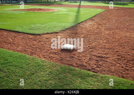 Le terrain de baseball pour les jeunes à partir de la première base à côté de la lumière du matin Banque D'Images