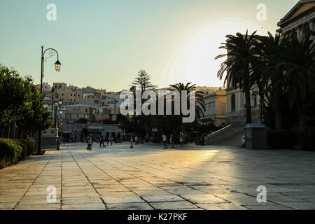 Après-midi lumière tombe sur la place miaouli, la place centrale (plateia) à Ermoupolis, Syros, Grèce, tandis que les enfants jouent en face de l'hôtel de ville. Banque D'Images