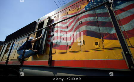 Un mécanicien de locomotive dans la maintient une zone de réparation et d'un triage ferroviaire de fret à Roseville, CA. Remarque US flag logo. Banque D'Images