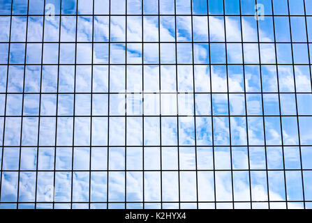 Ciel et nuages reflétée dans la façade de l'immeuble de verre bureau. Architecture moderne fragment. Banque D'Images