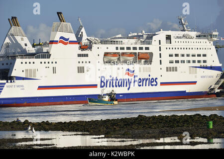 Ouistreham (Normandie, nord-ouest de la France) : petit chalutier voile devant un ferry appartenant à Brittany Ferries. Ici, le MV Mont-Saint-Michel f Banque D'Images