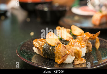 Les sushis de boeuf sur un plat noir Banque D'Images