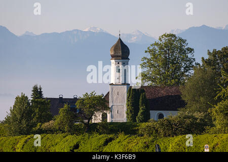 Eglise Saint Nicolas en face de la Préalpes bavaroises, Tutzing, Bavière, Allemagne Banque D'Images