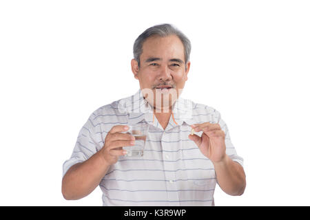 Asian senior man holding omega-3 capsule isolated on white Banque D'Images