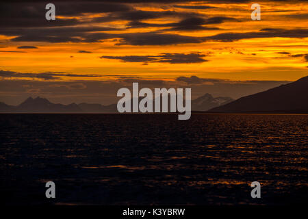 Lever du soleil reflétée dans la mer à Lyngenfjord au nord du cercle arctique, en Norvège au cours de l'été. Banque D'Images