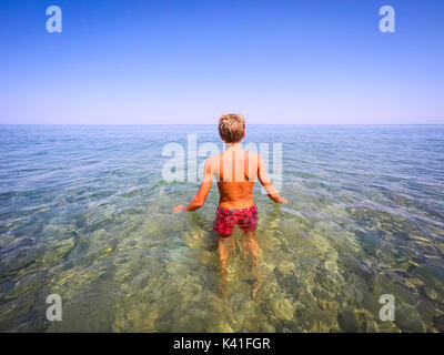 Adolescent prêt à nager dans la mer - summertime - Sicile mer méditerranée Banque D'Images