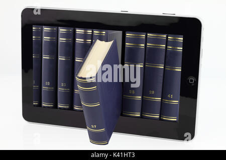 Tablet computer with books isolated on white Banque D'Images