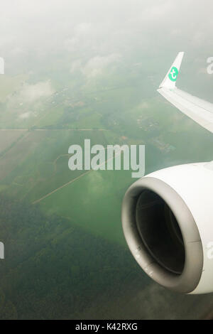 Moteur et l'aile d'un avion Transavia vu de la fenêtre de l'avion, voler par mauvais temps. Aux Pays-Bas. Banque D'Images