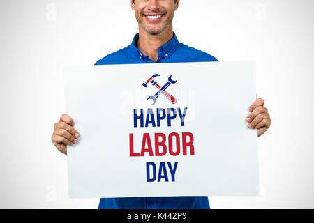 Portrait of happy man holding placard contre digital composite image texte de la fête du travail avec des outils Banque D'Images