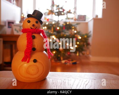 Handmade, woodturned bonhomme en face d'un arbre de Noël Banque D'Images