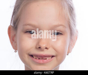 Close up of happy cute girl lui montrant l'évolution des dents. Banque D'Images