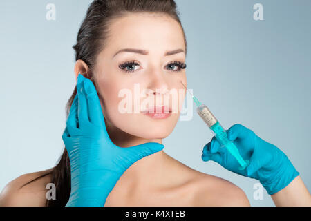 Portrait of young Beautiful woman getting injection face Banque D'Images