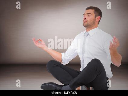 Digital composite of business man meditating contre mur rose Banque D'Images