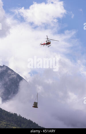 Arolla, Suisse - hélicoptère transporte matériel à la montagne, dans les Alpes valaisannes. Banque D'Images