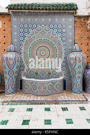 Fes, Maroc - 07 mai, 2017 : typique marocain fait main fontaine en mosaïque et des vases dans la cour de l'usine de mosaïque à Fès, au Maroc, afrique. Banque D'Images