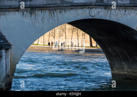 Bords de Seine avec les piétons vu à travers une arche de Pont Royal, Paris, France Banque D'Images