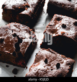 Brownies au chocolat noir sur du papier sulfurisé. Vue rapprochée des carrés Banque D'Images