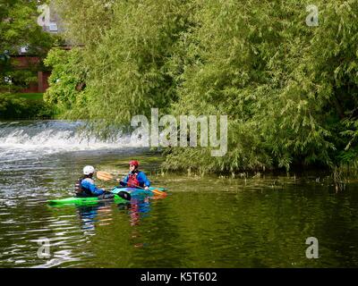 Deux canoéistes par le Lucy's Mill Weir et riverside apartments. rivière Avon, Stratford upon Avon, warks, Royaume-Uni. Banque D'Images