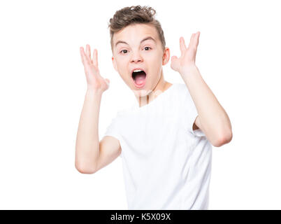 Portrait psychologique de l'étonné ou surpris teen boy en t-shirt blanc. funny cute cheerful enfant hurlant de bouche grande ouverte, isolated on white backg Banque D'Images