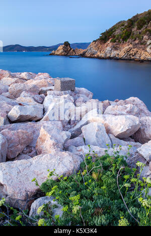 Plage avec des roches blanches au crépuscule, Punta Ala, Toscane, Italie. Banque D'Images