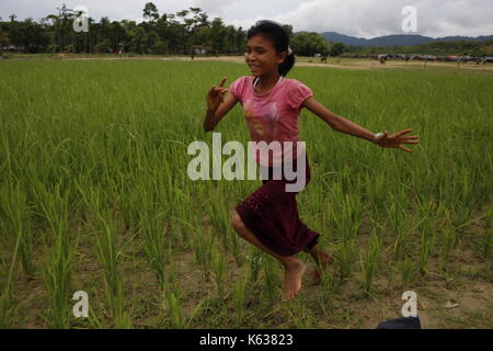 Teknaf, Bangladesh. 10 septembre 2017. Les enfants réfugiés Rohingya jouent sur la zone de terre de No man près de la frontière entre le Bangladesh et le Myanmar, à Naikhongchhari, Bandarban. Le réfugié Rohingya marche sur un sentier boueux après avoir traversé la frontière entre le Bangladesh et le Myanmar, à Teknaf. Crédit: Md Mehedi Hasan/Pacific Press/Alay Live News Banque D'Images